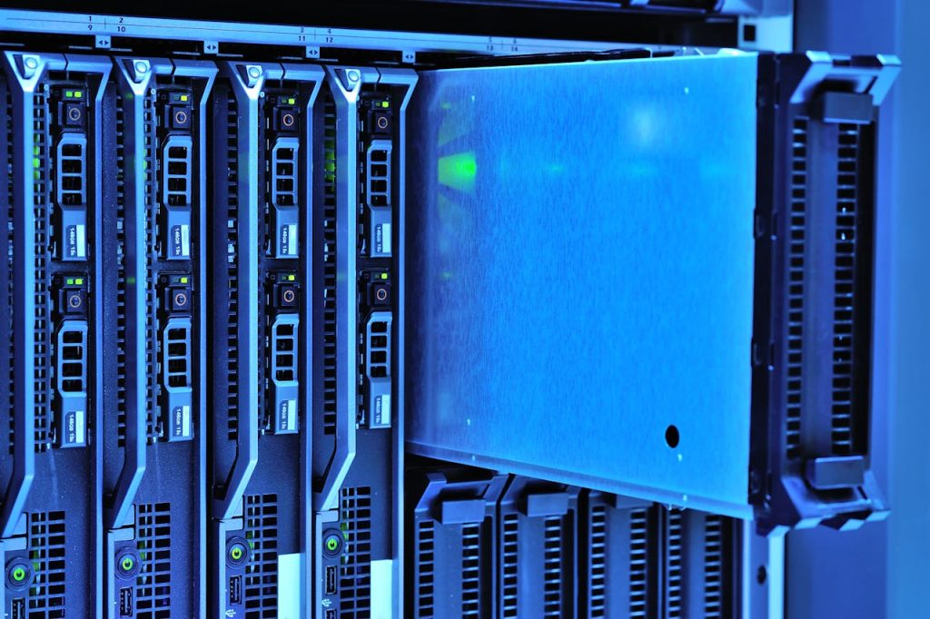 pexels-photo-17489153 Detailed view of server racks with glowing lights in a data center environment.