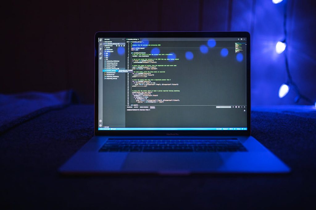pexels-photo-6424590 Close-up of a laptop screen displaying code, set against a dark backdrop with blue lighting for a tech-focused ambiance.